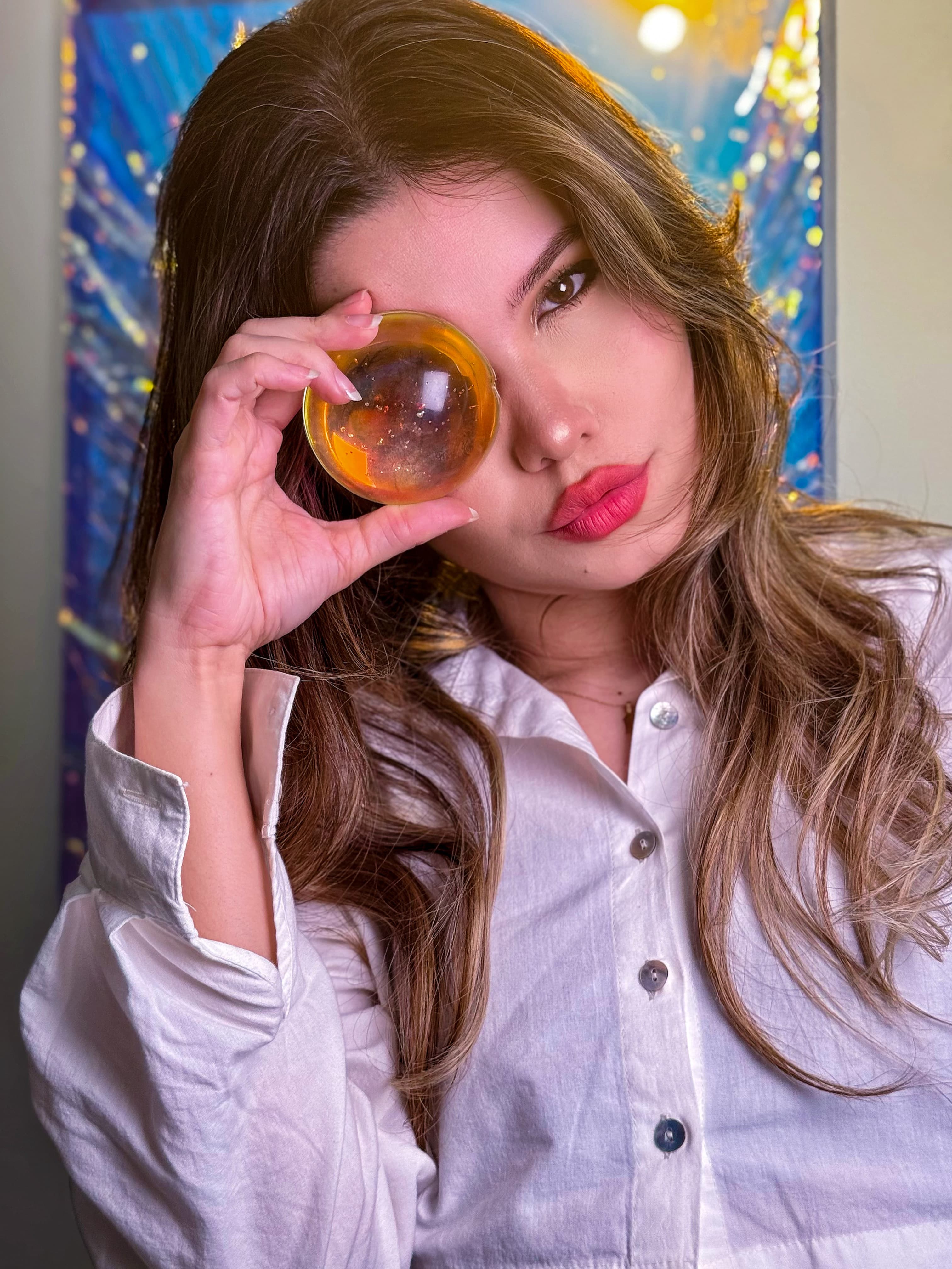 Anny Schäfer in her studio holding a resin sphere